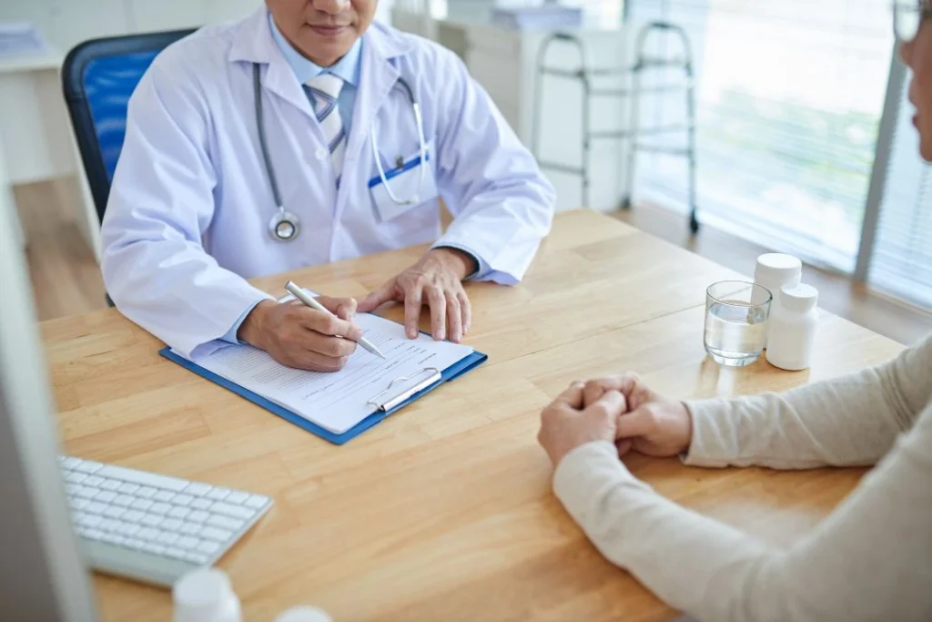 Doctor in white coat with patient