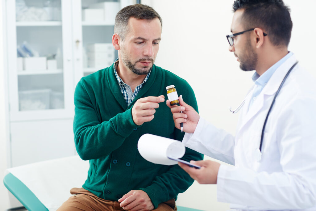 Doctor explaining medication to patient in clinic.