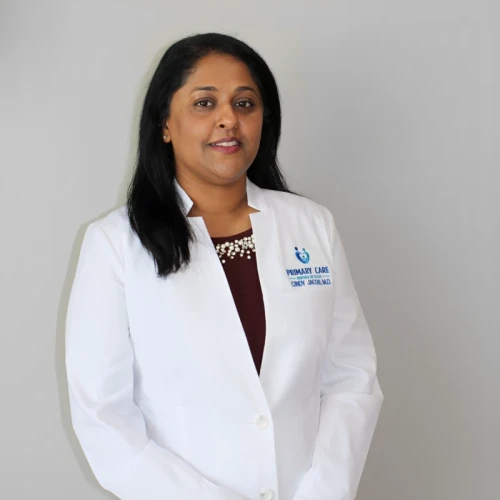 Female doctor wearing white coat, smiling confidently.