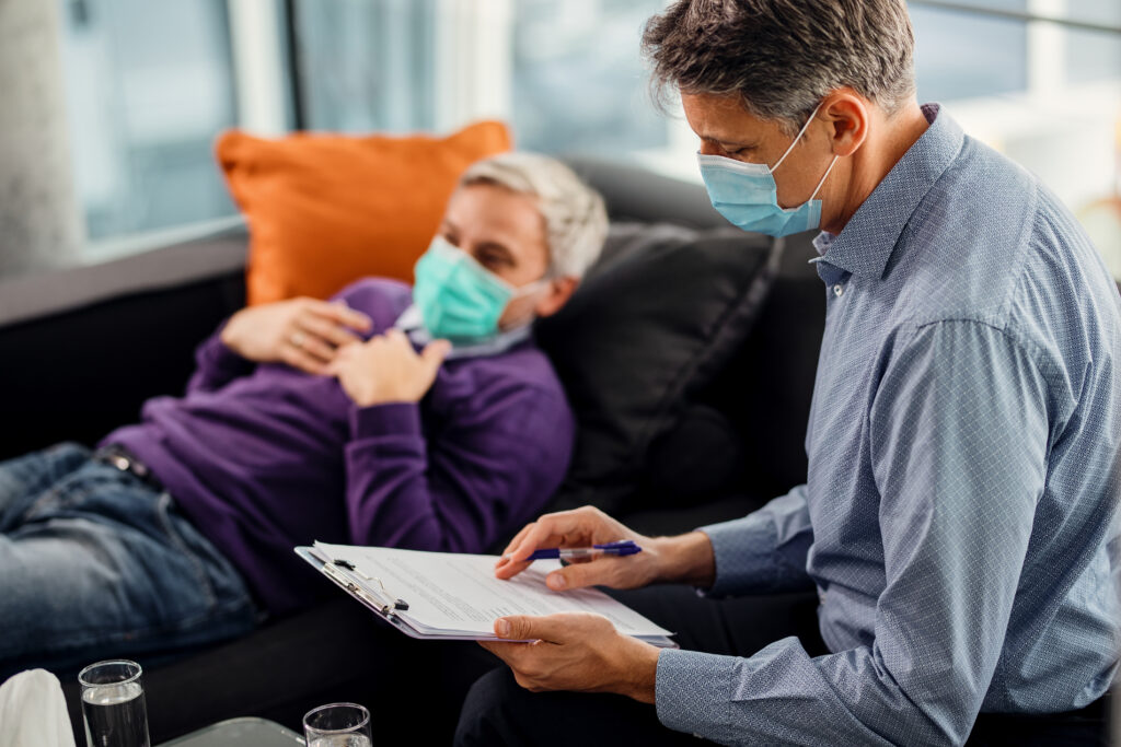 Doctor reviewing patient’s form during consultation.