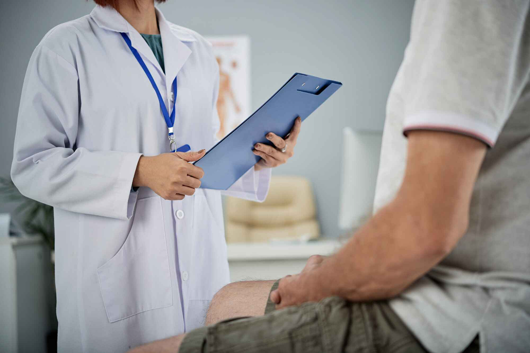 Doctor holding a clipboard with a patient.