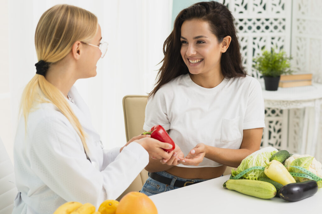 Nutritionist discussing healthy food with patient.